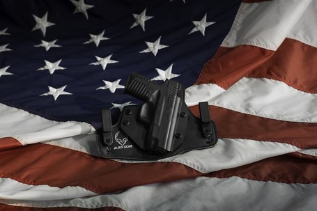 concealed gun on top of american flag