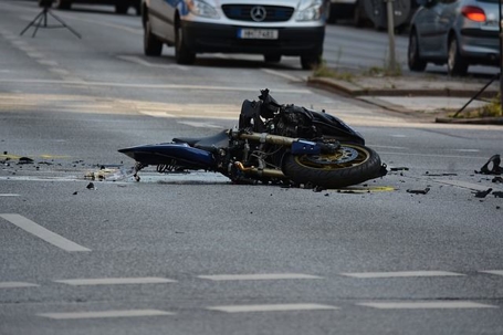 A crashed motorcycle in the streets.